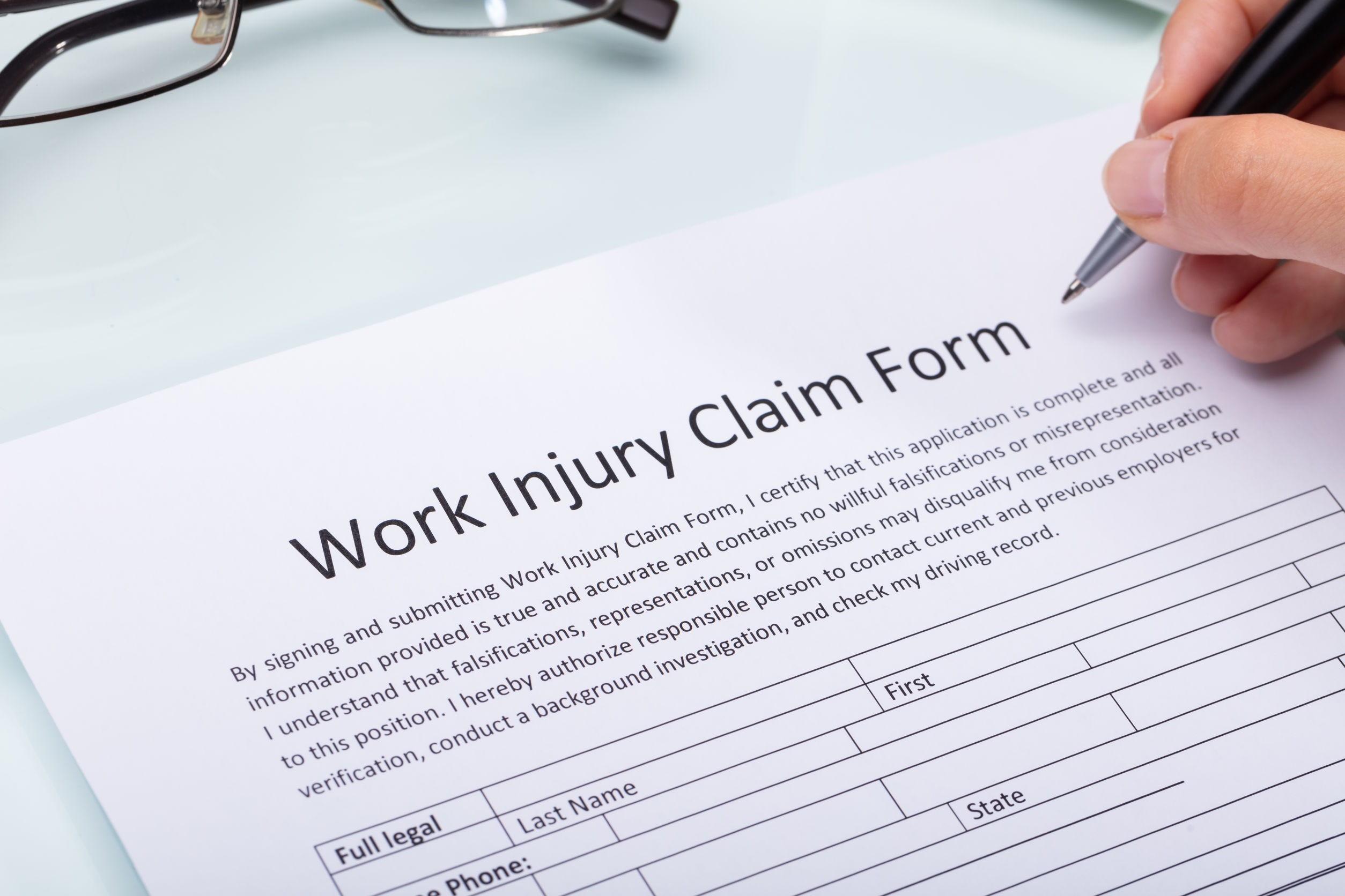Woman Filling Work Injury Claim Form
